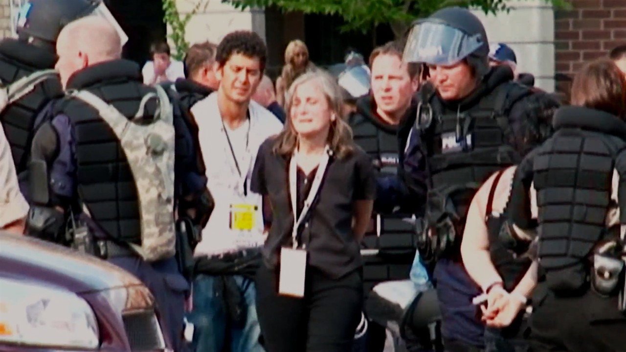 Archival footage of Amy Goodman being arrested